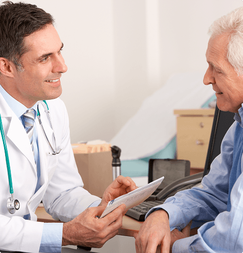 Physician discussing Prostate Artery Embolization candidacy with patient Physician discussing Prostate Artery Embolization candidacy with patient