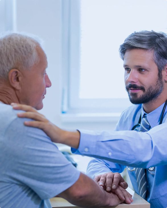 doctor-reassuring-senior-patient-with-hand-on-shoulder Doctor reassuring an elderly patient with a comforting hand on the shoulder