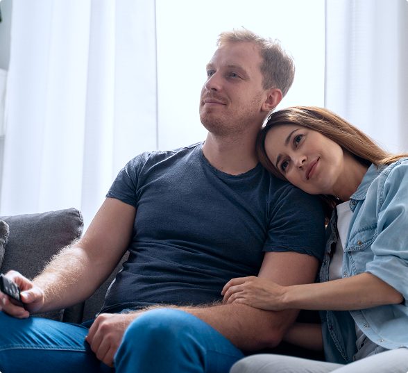 Young couple relaxing together on the couch at home